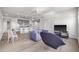 Open concept living space with a modern kitchen, dining area, and living room featuring light hardwood floors at 205 5Th N Ave # 501, St Petersburg, FL 33701