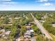 Scenic aerial view of homes nestled in a lush, tree-filled neighborhood at 2078 Madrid N Ct, Clearwater, FL 33763
