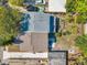 Aerial view of the property showcasing the roof, backyard, driveway, and nearby trees at 2078 Madrid N Ct, Clearwater, FL 33763