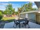 Backyard with a patio dining set and lush greenery, perfect for enjoying the outdoors at 2078 Madrid N Ct, Clearwater, FL 33763