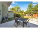 Backyard patio offers a serene outdoor dining area with a view of the spacious, green landscape at 2078 Madrid N Ct, Clearwater, FL 33763