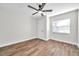 This bedroom features a ceiling fan, wooden floors, and a window at 2078 Madrid N Ct, Clearwater, FL 33763