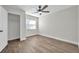 This bedroom features a ceiling fan, wooden floors, and a closet at 2078 Madrid N Ct, Clearwater, FL 33763
