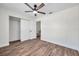This bedroom features a ceiling fan, wooden floors, and a closet at 2078 Madrid N Ct, Clearwater, FL 33763