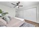 Cozy bedroom with a ceiling fan, multiple closets, and stylish decor for comfort at 2078 Madrid N Ct, Clearwater, FL 33763