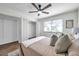 This bedroom features a ceiling fan, wooden floors, a large closet, and a window with white blinds at 2078 Madrid N Ct, Clearwater, FL 33763