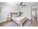 Inviting bedroom with a ceiling fan, neutral decor, and modern furnishings at 2078 Madrid N Ct, Clearwater, FL 33763