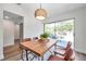 Bright dining area features stylish chairs, modern lighting, and access to the backyard at 2078 Madrid N Ct, Clearwater, FL 33763
