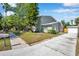 Charming home with driveway, landscaped yard, and detached garage offers curb appeal at 2078 Madrid N Ct, Clearwater, FL 33763