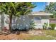 Charming home exterior with a beautifully landscaped front yard, healthy plants, and mature trees at 2078 Madrid N Ct, Clearwater, FL 33763