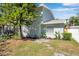 Charming home exterior with a beautifully landscaped front yard, healthy plants, and mature trees at 2078 Madrid N Ct, Clearwater, FL 33763