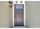 Elegant front door with decorative glass and stylish light fixture enhances the home's entrance at 2078 Madrid N Ct, Clearwater, FL 33763