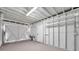 Spacious garage featuring open storage shelving, overhead lighting and a convenient garage door at 2078 Madrid N Ct, Clearwater, FL 33763
