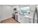 Bright kitchen features white cabinetry, stainless appliances, and a sleek, modern design at 2078 Madrid N Ct, Clearwater, FL 33763