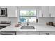 Kitchen with quartz countertops, subway tile backsplash, and a backyard view at 2078 Madrid N Ct, Clearwater, FL 33763