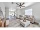 Cozy living room with wood-look floors and a view of the dining area at 2078 Madrid N Ct, Clearwater, FL 33763