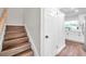 Staircase leading to the upper level, showcasing the home's layout and design at 2078 Madrid N Ct, Clearwater, FL 33763