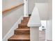 Wooden staircase leading to the upper level, showcasing the home's transition between floors at 2078 Madrid N Ct, Clearwater, FL 33763