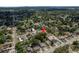 Wide aerial shot shows property's location amidst lush greenery in a tranquil neighborhood setting at 2104 E Navajo Ave, Tampa, FL 33612