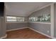 Bedroom with hardwood floors, neutral paint, and natural light from multiple windows at 2104 E Navajo Ave, Tampa, FL 33612