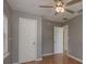 Bedroom with hardwood floors, closet, neutral paint, and natural light from the windows at 2104 E Navajo Ave, Tampa, FL 33612