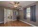 Cozy bedroom with neutral paint, hardwood floors, ceiling fan and natural light from the windows at 2104 E Navajo Ave, Tampa, FL 33612