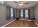 Comfortable bedroom with hardwood floors, ceiling fan, natural light and three windows at 2104 E Navajo Ave, Tampa, FL 33612