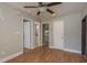 Spacious living room with hardwood floors and multiple doorways, offering easy access to different areas of the home at 2104 E Navajo Ave, Tampa, FL 33612