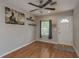 Cozy living room with hardwood floors, ceiling fan, and stylish decor art, creating a welcoming atmosphere at 2104 E Navajo Ave, Tampa, FL 33612