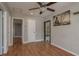 Bright living room featuring hardwood floors, white trim, and access to kitchen and other rooms at 2104 E Navajo Ave, Tampa, FL 33612