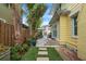 Landscaped backyard featuring a stone path leading to a pool with a table and an umbrella at 221 13Th Ne Ave, St Petersburg, FL 33701