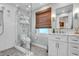 Bathroom featuring a marble vanity top, glass shower and honeycomb tile floors at 221 13Th Ne Ave, St Petersburg, FL 33701