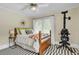 Bedroom with wood bed frame, accent pillows, ceiling fan and unique striped rug at 221 13Th Ne Ave, St Petersburg, FL 33701