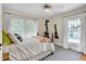 Bedroom with wood bed frame, accent pillows, ceiling fan and unique striped rug at 221 13Th Ne Ave, St Petersburg, FL 33701