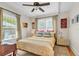 Bedroom featuring neutral walls, modern ceiling fan and bed dressed in bright yellow linens at 221 13Th Ne Ave, St Petersburg, FL 33701