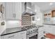 Close up of a stylish kitchen with stainless steel range and hood, plus decorative backsplash at 221 13Th Ne Ave, St Petersburg, FL 33701