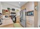 Kitchen featuring stainless steel appliances, breakfast bar with seating, and natural wood cabinets at 221 13Th Ne Ave, St Petersburg, FL 33701