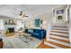Comfortable living room features a fireplace, hardwood floors, and staircase, creating a warm and inviting atmosphere at 221 13Th Ne Ave, St Petersburg, FL 33701