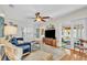 Bright and airy living room with hardwood floors, a cozy seating area, and seamless access to the sunroom at 221 13Th Ne Ave, St Petersburg, FL 33701