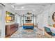 Well-lit main bedroom with stylish furniture, ceiling fan, and large windows with white curtains at 221 13Th Ne Ave, St Petersburg, FL 33701