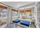 Cozy sunroom with a daybed and ample windows offering a bright, relaxing space with views of the neighborhood at 221 13Th Ne Ave, St Petersburg, FL 33701
