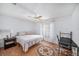 Bright bedroom featuring wood-look flooring and a ceiling fan for added comfort at 2632 Tung Dr, Holiday, FL 34691
