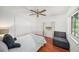 Cozy bedroom with natural light, closet, and a comfortable seating area at 2632 Tung Dr, Holiday, FL 34691