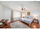Bedroom with a blue bed, wood floors, neutral rug and a ceiling fan at 2632 Tung Dr, Holiday, FL 34691