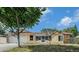 Charming single-story home with a well-manicured lawn, attached garage, and inviting curb appeal at 2632 Tung Dr, Holiday, FL 34691