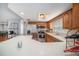 Bright kitchen with stainless steel appliances, wood cabinets, and a breakfast bar at 2632 Tung Dr, Holiday, FL 34691
