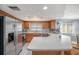 Kitchen featuring stainless steel refrigerator, wooden cabinets, and an island at 2632 Tung Dr, Holiday, FL 34691