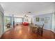 Bright living room with a glass dining table, hardwood floors, and open floorplan for easy entertaining at 2632 Tung Dr, Holiday, FL 34691