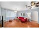 Bright living room with a red couch set, wood floors, and arched doorway to another room at 2632 Tung Dr, Holiday, FL 34691