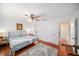 Bedroom with a blue bed, wood floors, neutral rug and a ceiling fan at 2632 Tung Dr, Holiday, FL 34691